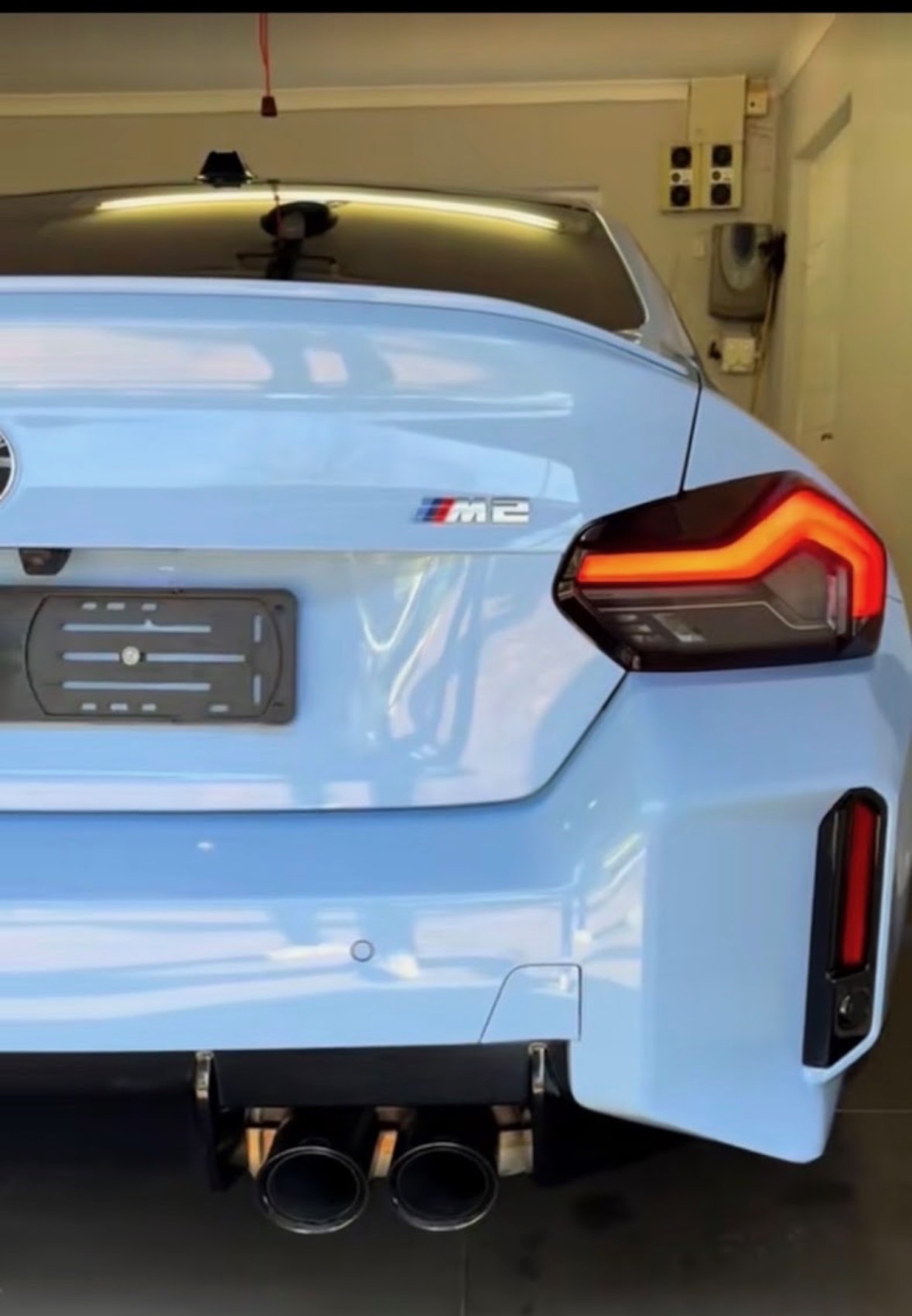 Ice blue BMW M2 rear detail with paint protection film applied at D2 Customs