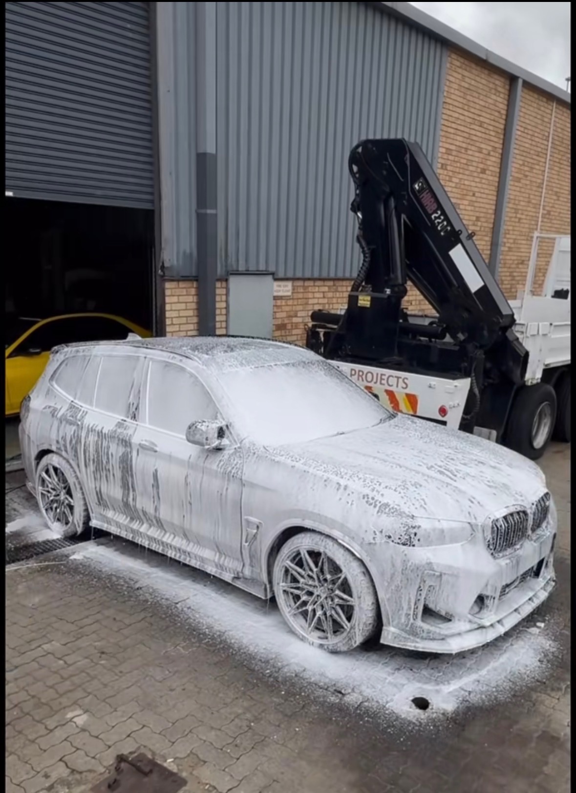 BMW X3 M covered in snow foam during a safe wash at D2 Customs Johannesburg