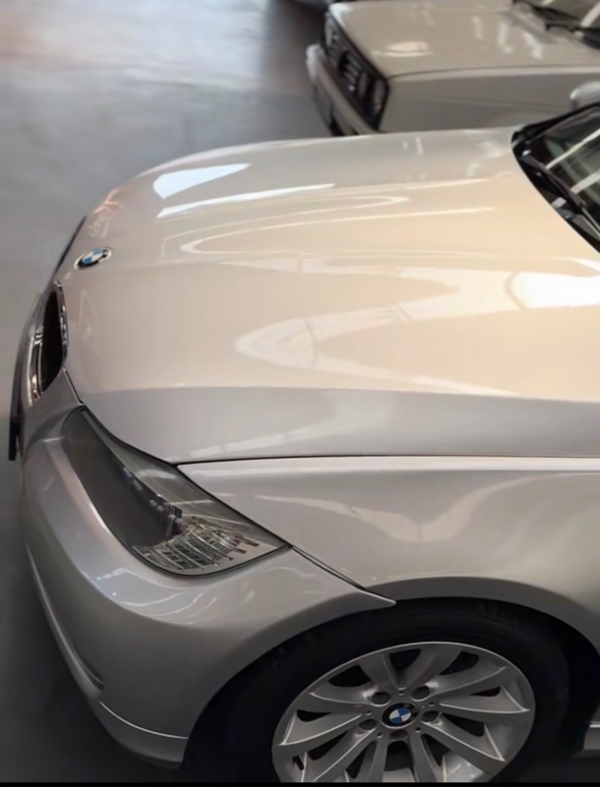 Silver BMW bonnet showing mirror gloss reflections after machine polishing